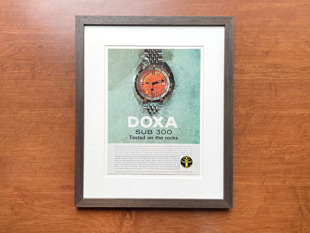 1968 Doxa SUB 300 "Tested on the rocks" Advertisement in Brown Wood Frame