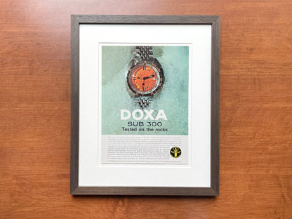 1968 Doxa SUB 300 "Tested on the rocks" Advertisement in Brown Wood Frame