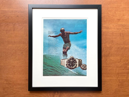 1978 Rolex "Red" Submariner Ref. 1680 with Surfer Advertisement in Black Wood Frame