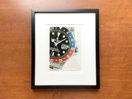Original Rolex Catalog Page featuring GMT Master Ref. 1675 image in Black Wood Frame